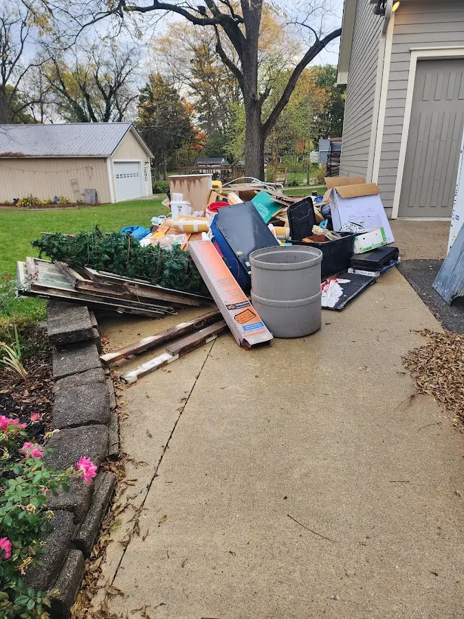 Dumpster being loaded with debris for Commercial Dumpster Rental in Little Compton